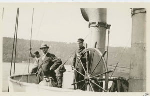 Image of Jack Barnes at wheel of Roosevelt - George Borup in distance